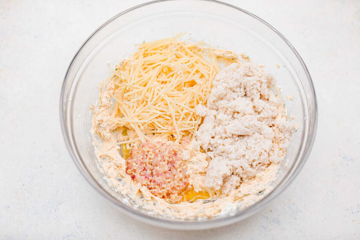 Overhead shot of the cream cheese mixture with cheese, crab meat, garlic and shallot mixture.