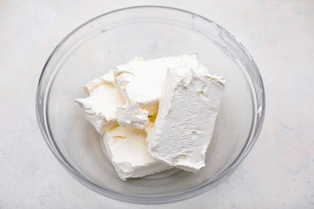 Blocks of cream cheese in a bowl.