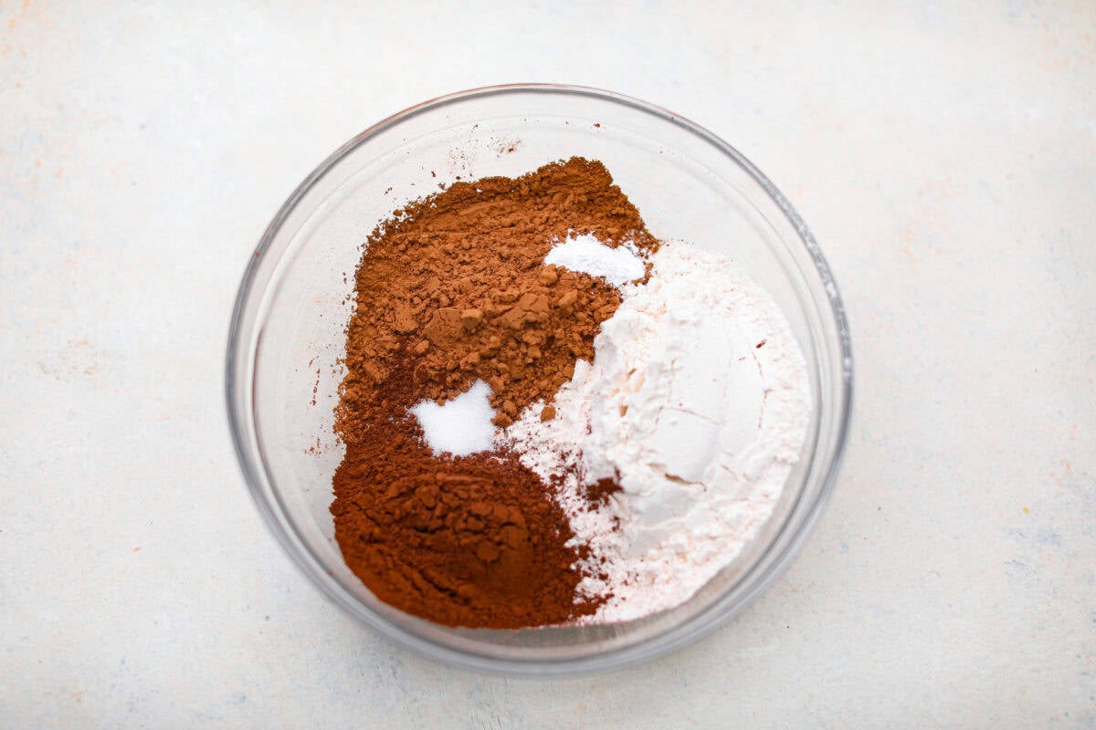 Overhead shot of cocoa powders, salt, baking powder, and flour in a separate mixing bowl. 