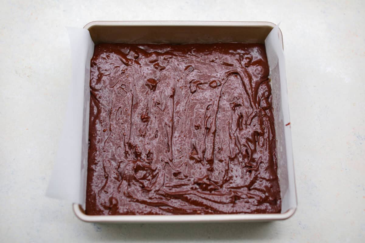 Overhead shot of Guinness brownie batter in a baking pan. 