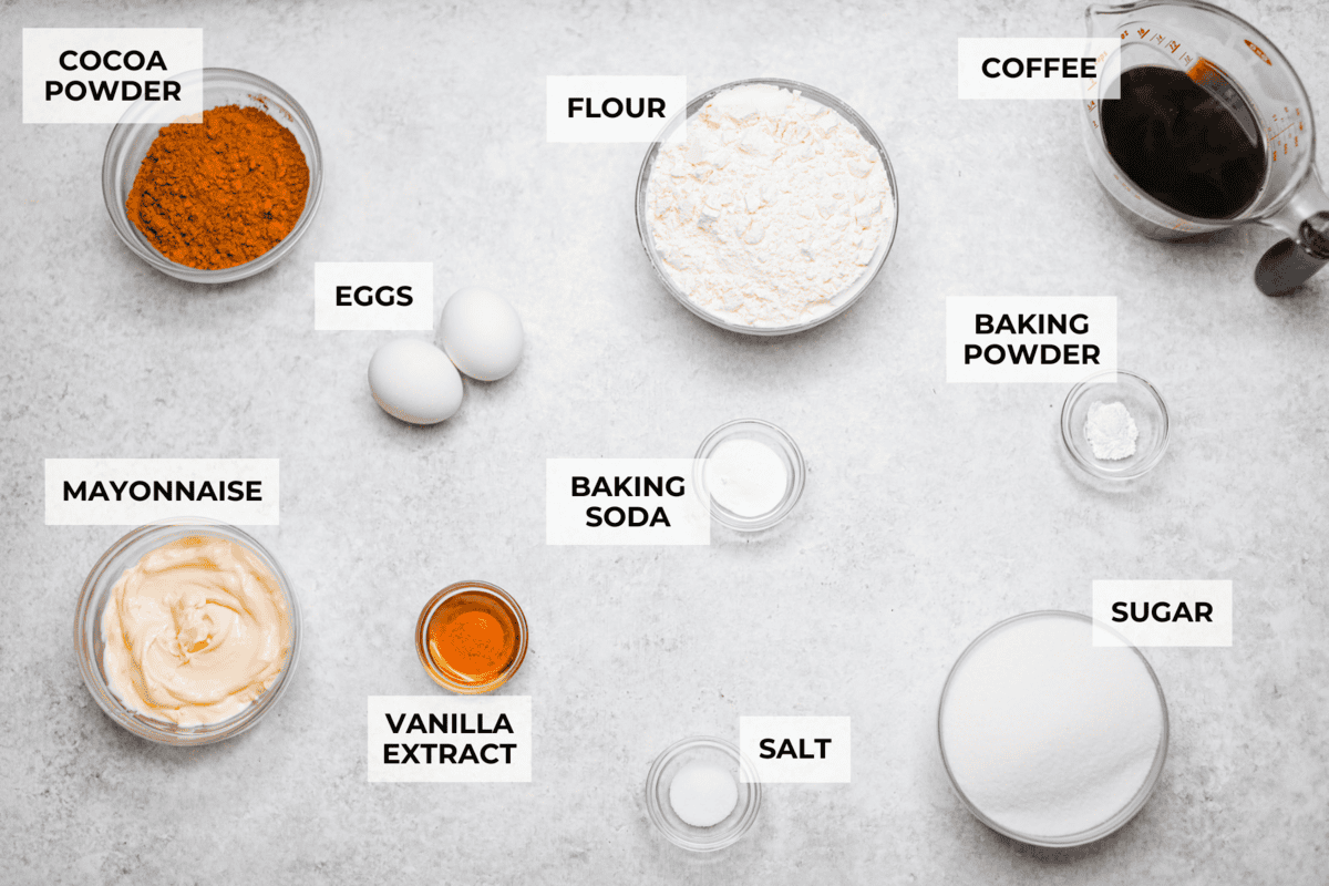 Chocolate Mayonnaise Cake is a rich, moist, and decadent dessert that’s super easy to make! The mayonnaise adds extra moisture and creates a soft, tender crumb. Whether for a special occasion or just because it's sure to impress! Overhead shot of labeled ingredients.