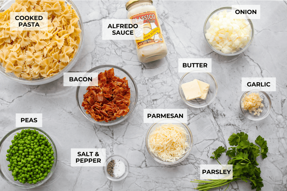 Stanley Tucci pasta casserole is everything you want in a casserole. It's simple to make and incredibly flavorful! TikTok is going crazy over the crispy bacon, tender peas, and the creamy, cheesy sauce that holds everything together! Overhead shot of labeled ingredients.