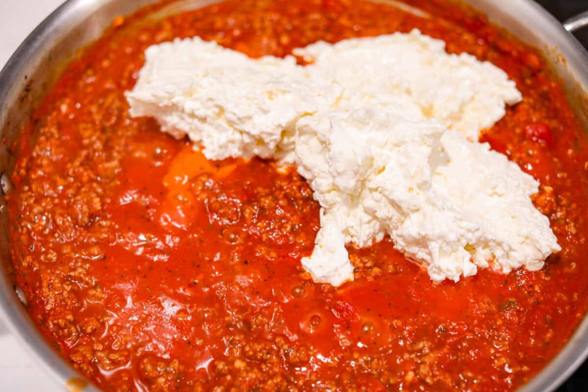 Overhead shot of meat sauce with the cheese mixture on top. 