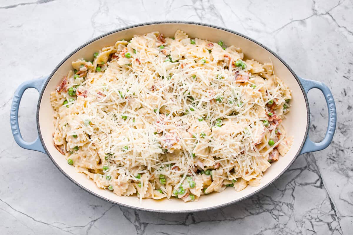 Stanley Tucci pasta casserole is everything you want in a casserole. It's simple to make and incredibly flavorful! TikTok is going crazy over the crispy bacon, tender peas, and the creamy, cheesy sauce that holds everything together! Overhead shot of all of the ingredients in a baking dish.