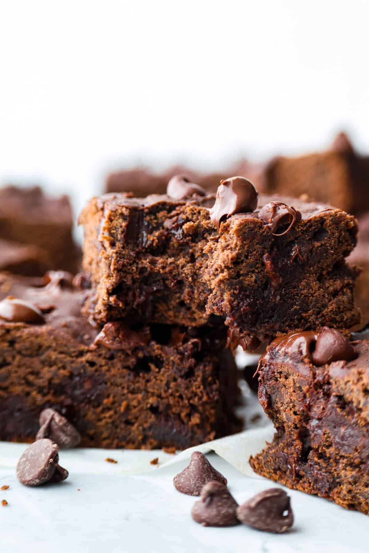 Close up shot of a black bean brownie with a bite taken out of it. 