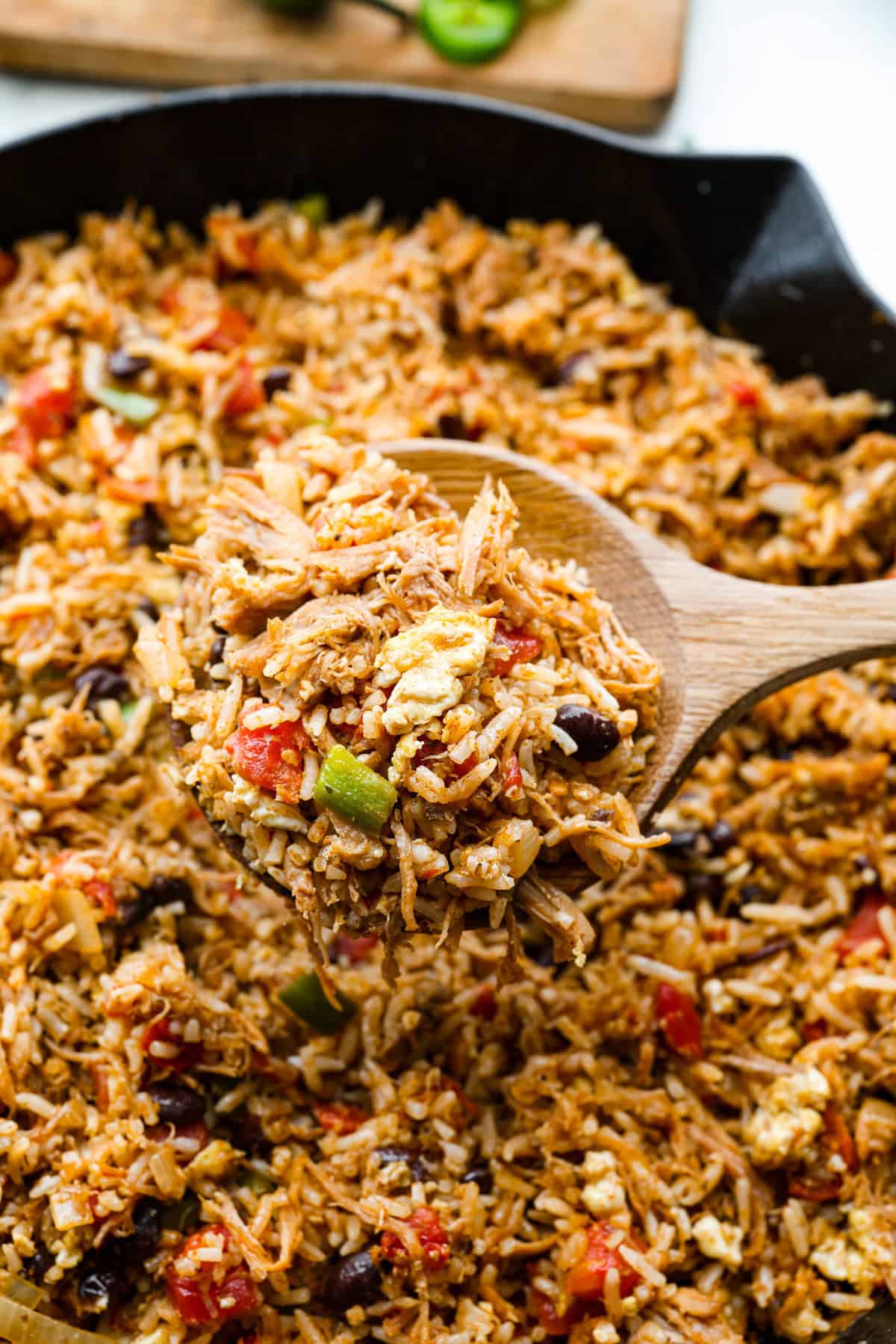Cowboy Fried Rice is a Tex-Mex twist on the classic! It's loaded with bold spices and hearty ingredients like pulled pork, black beans, and diced tomatoes. Made in one skillet and ready in just 30 minutes, it’s the perfect quick and satisfying meal for busy nights. Close up shot of cowboy fried rice.