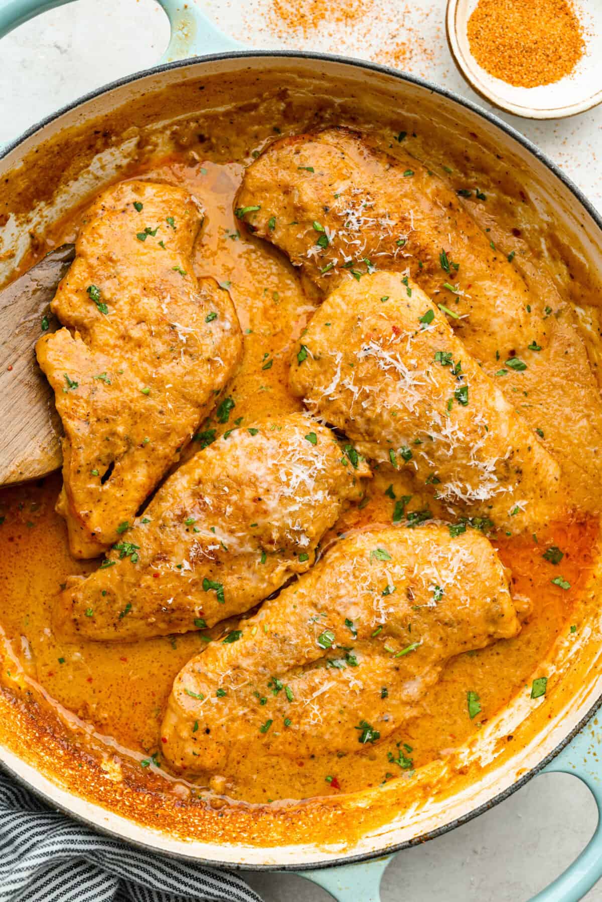 Overhead shot of creamy cajun chicken in a skillet. 