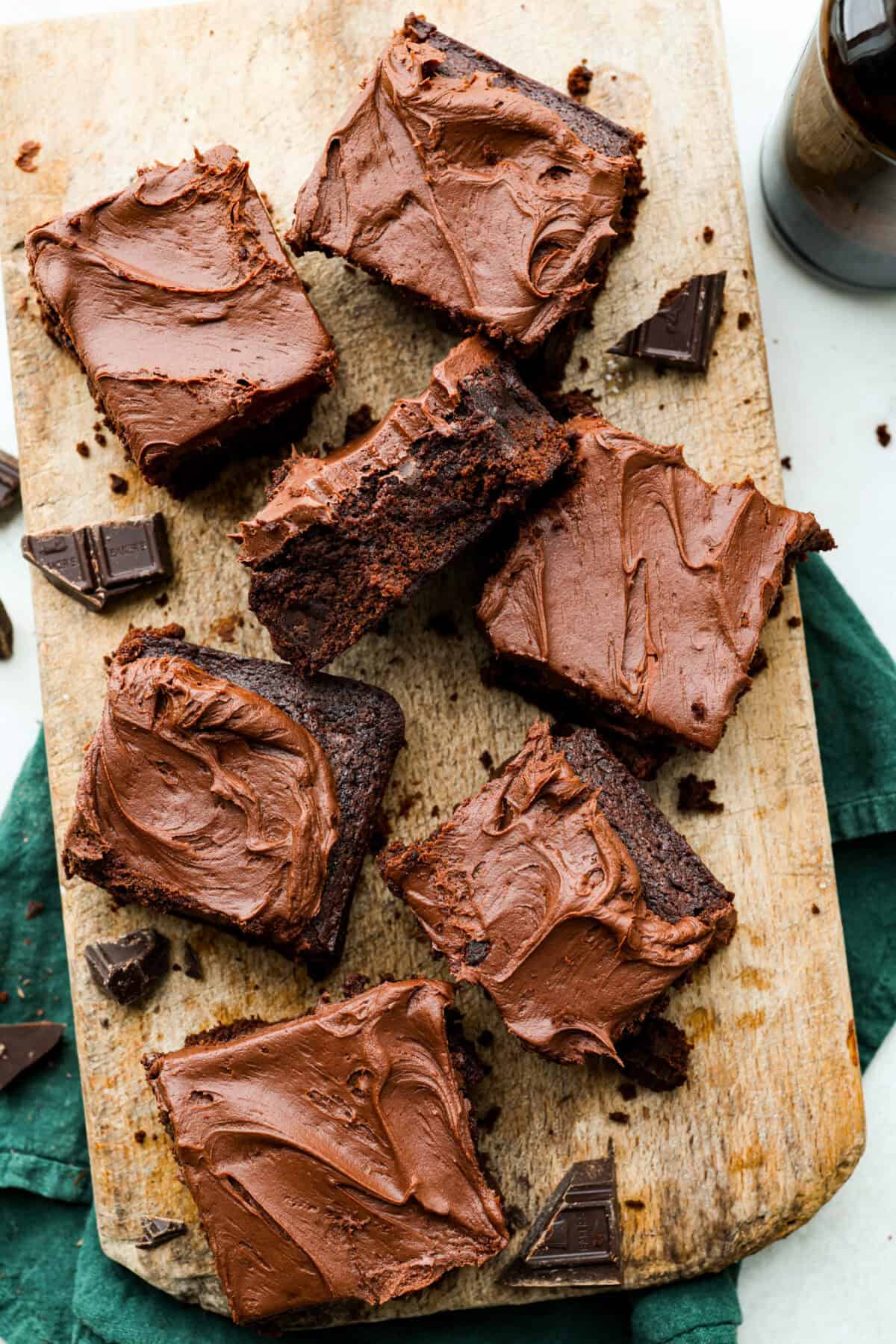 Overhead shot of servings of Guinness brownies on a wooden serving board. 