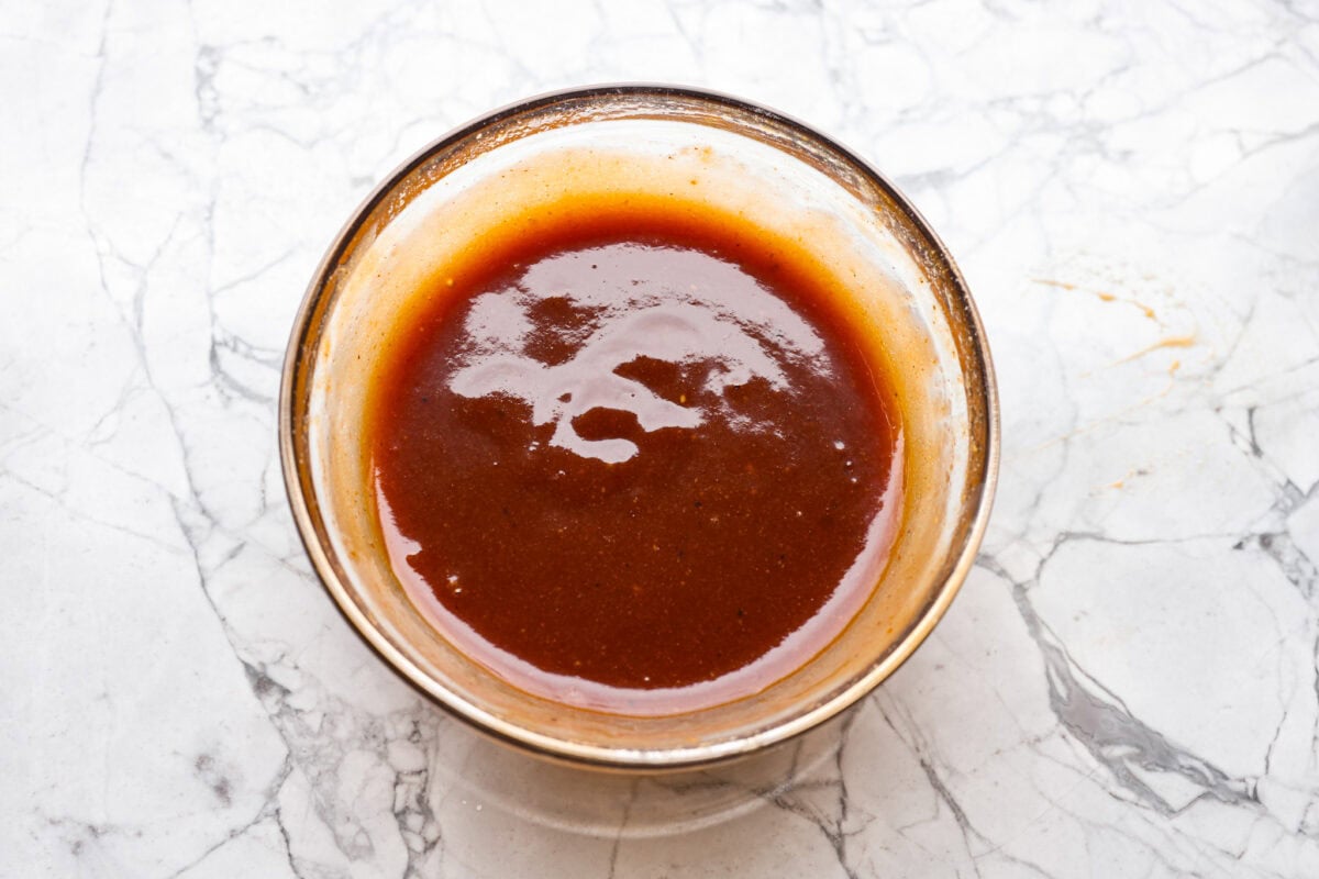 Overhead shot of glaze ingredients whisked together in a bowl. 