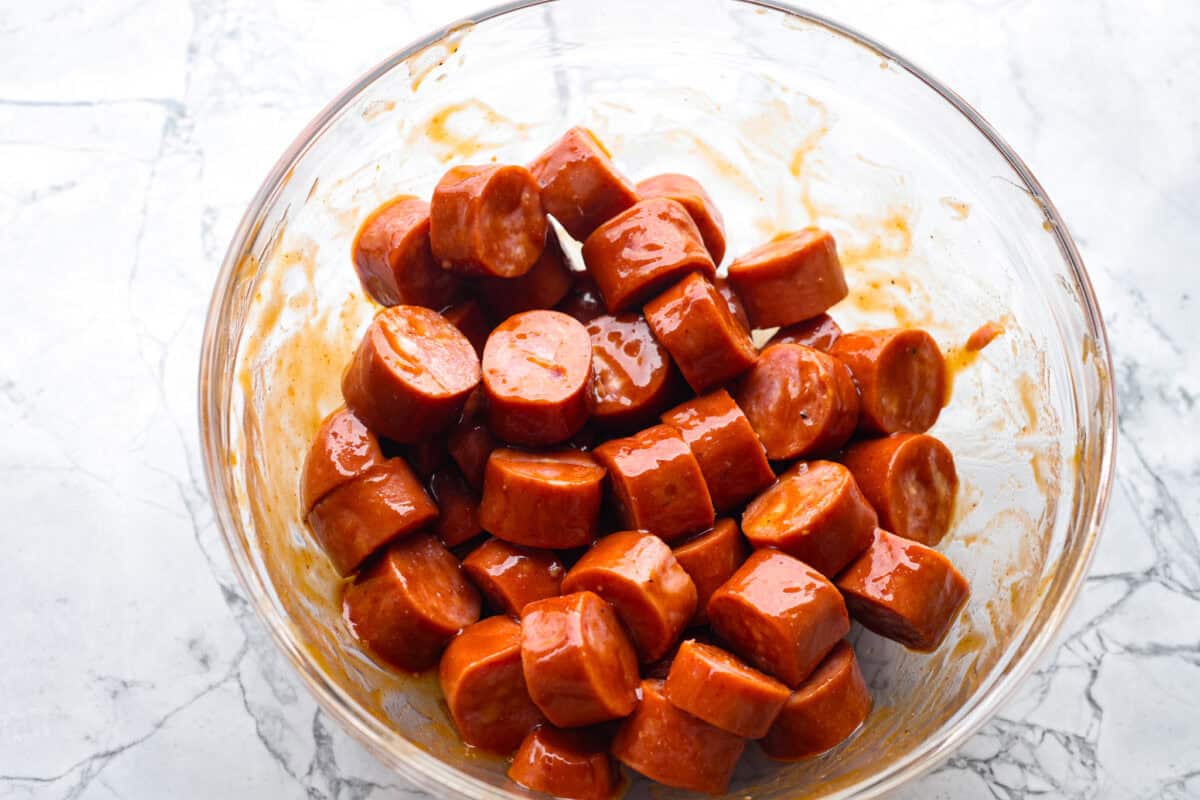 Overhead shot of sausage bites mixed with the glaze. 