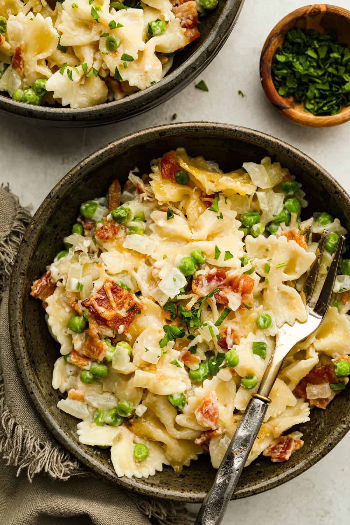 Stanley Tucci pasta casserole is everything you want in a casserole. It's simple to make and incredibly flavorful! TikTok is going crazy over the crispy bacon, tender peas, and the creamy, cheesy sauce that holds everything together! Overhead shot of plated Stanley Tucci pasta casserole.