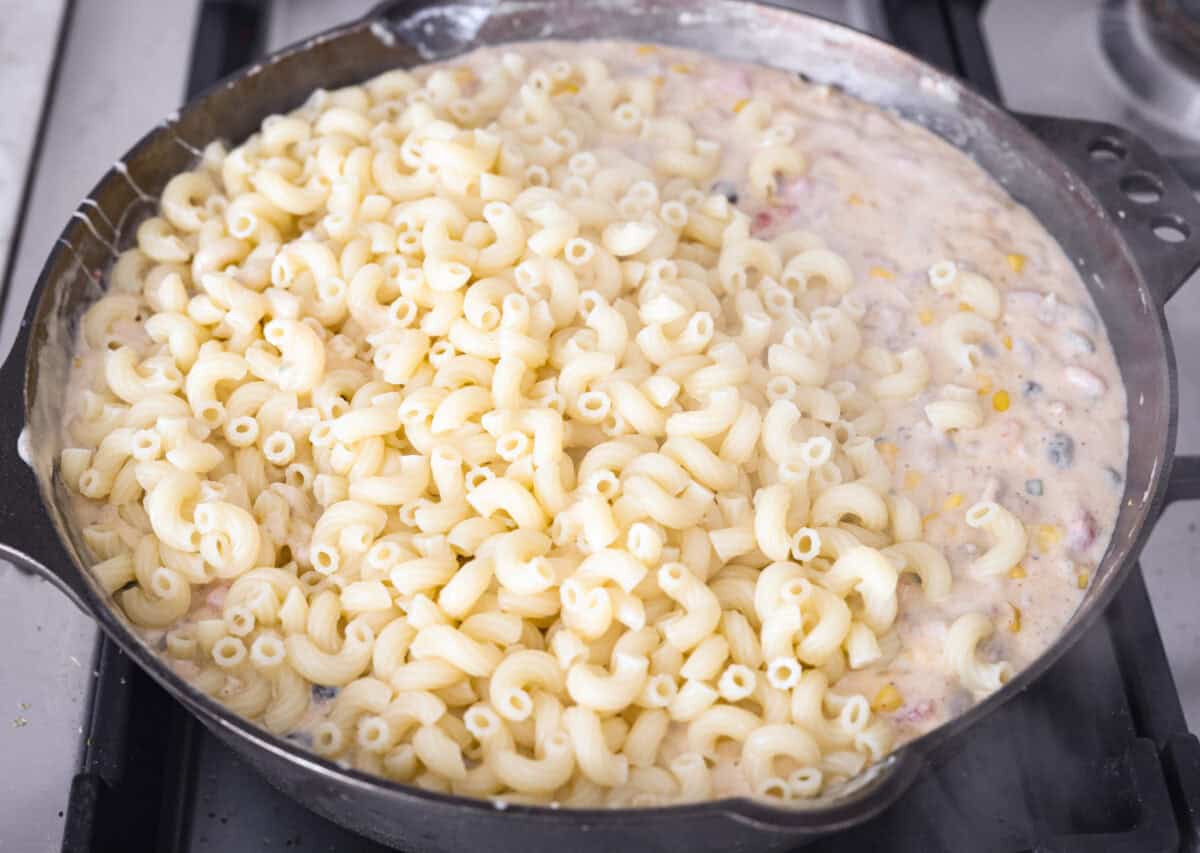 Cooked noodles are added to the skillet with the cheesy, creamy beef mixture. 