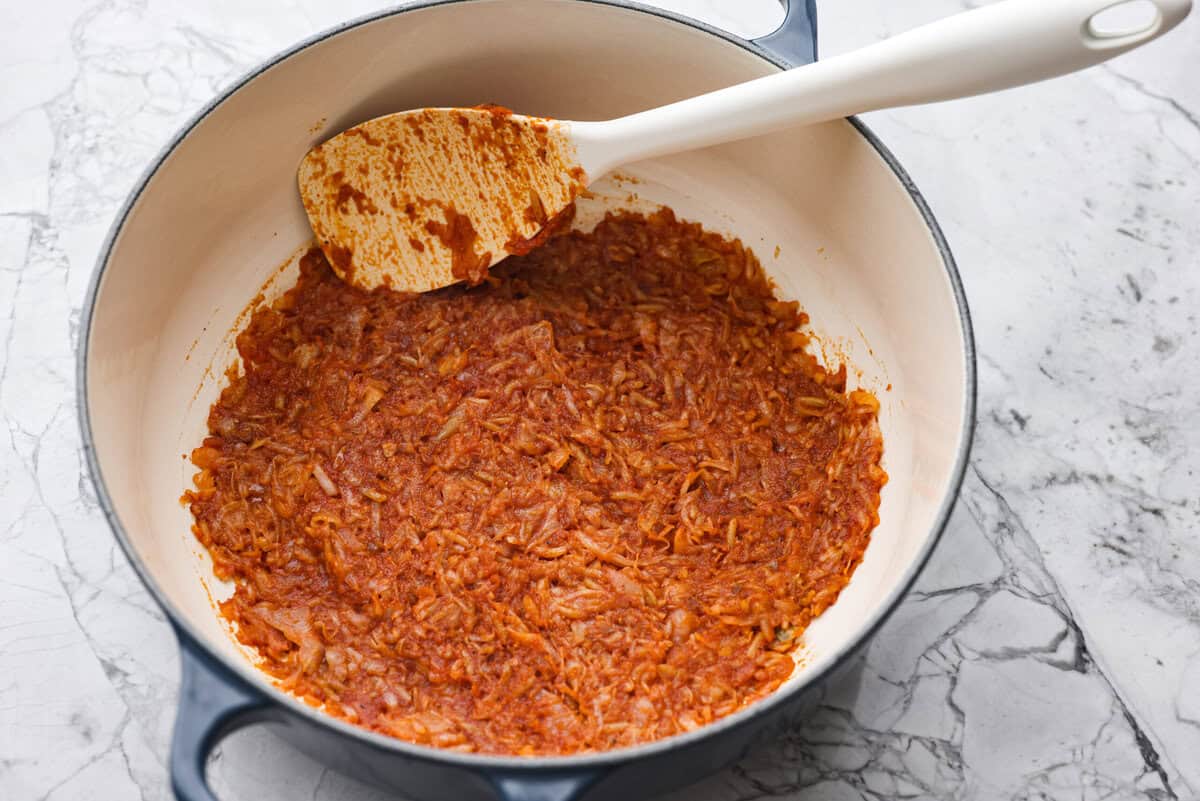 Hungarian cabbage rolls are packed with rich, hearty flavors in every bite! I know you love a good cabbage roll and can’t get enough of my Hungarian goulash, so I knew this recipe would be perfect. Overhead shot of the Hungarian roll cabbage stuffing in the bottom of a dutch oven.