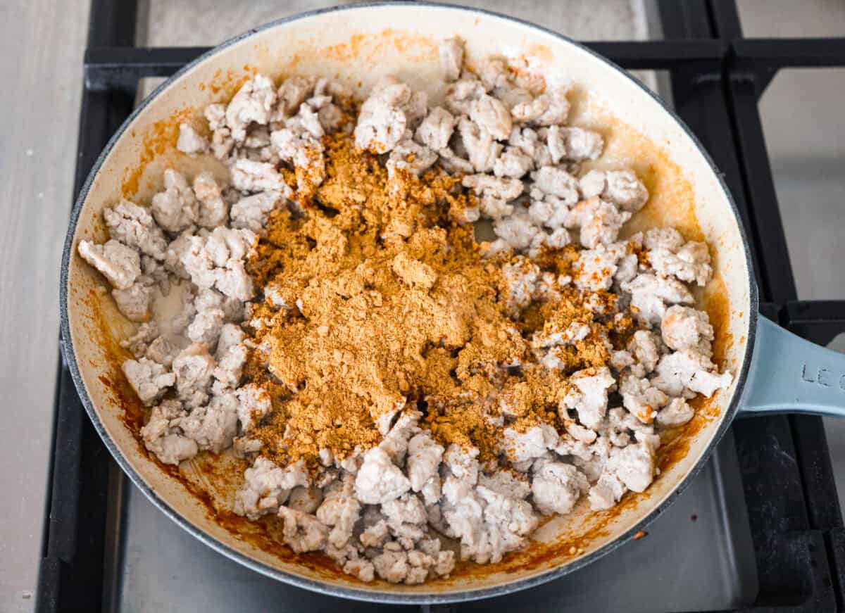 Overhead shot of cooking ground turkey with  taco seasoning added to it. 