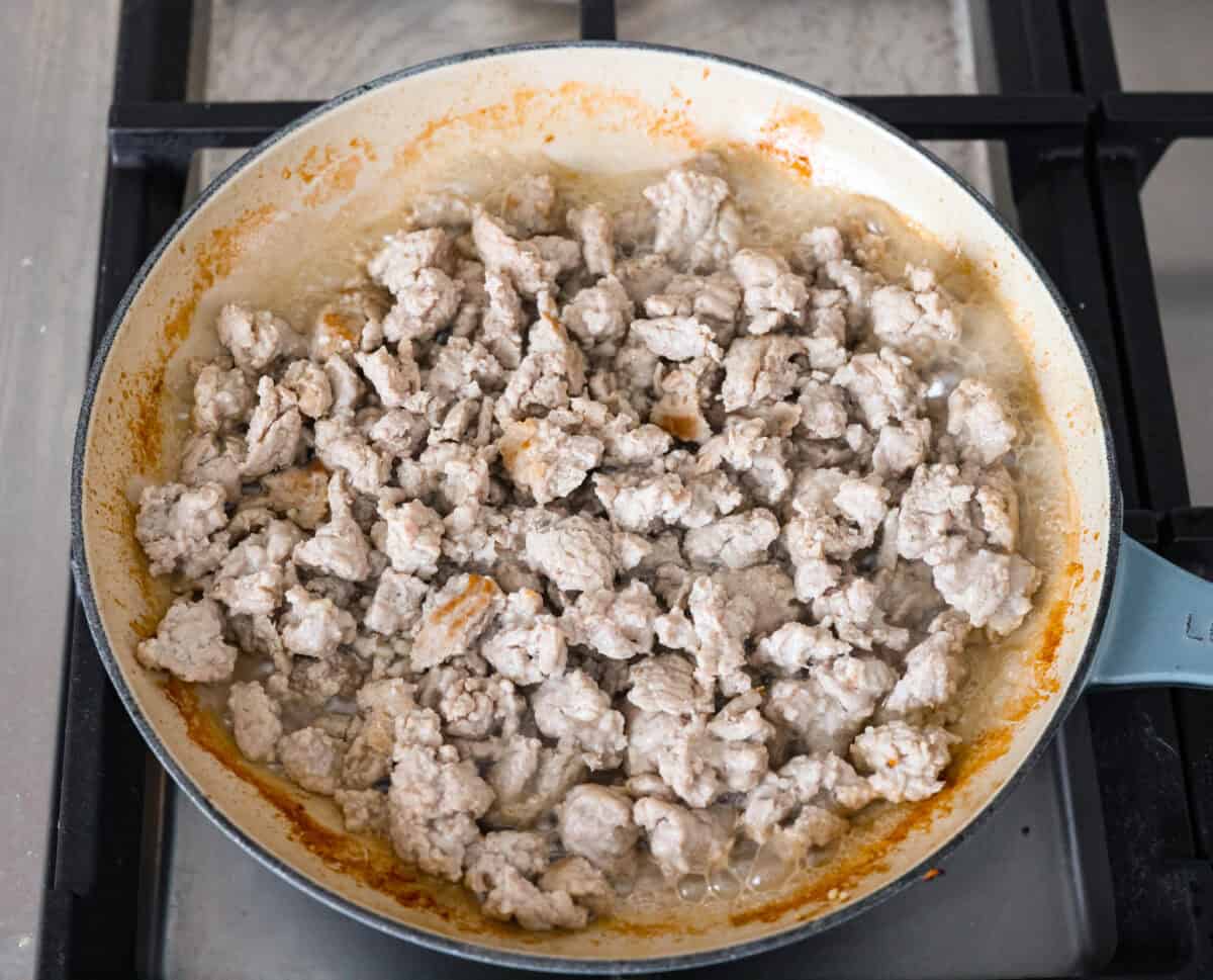 Overhead shot of ground turkey cooking in a skillet. 