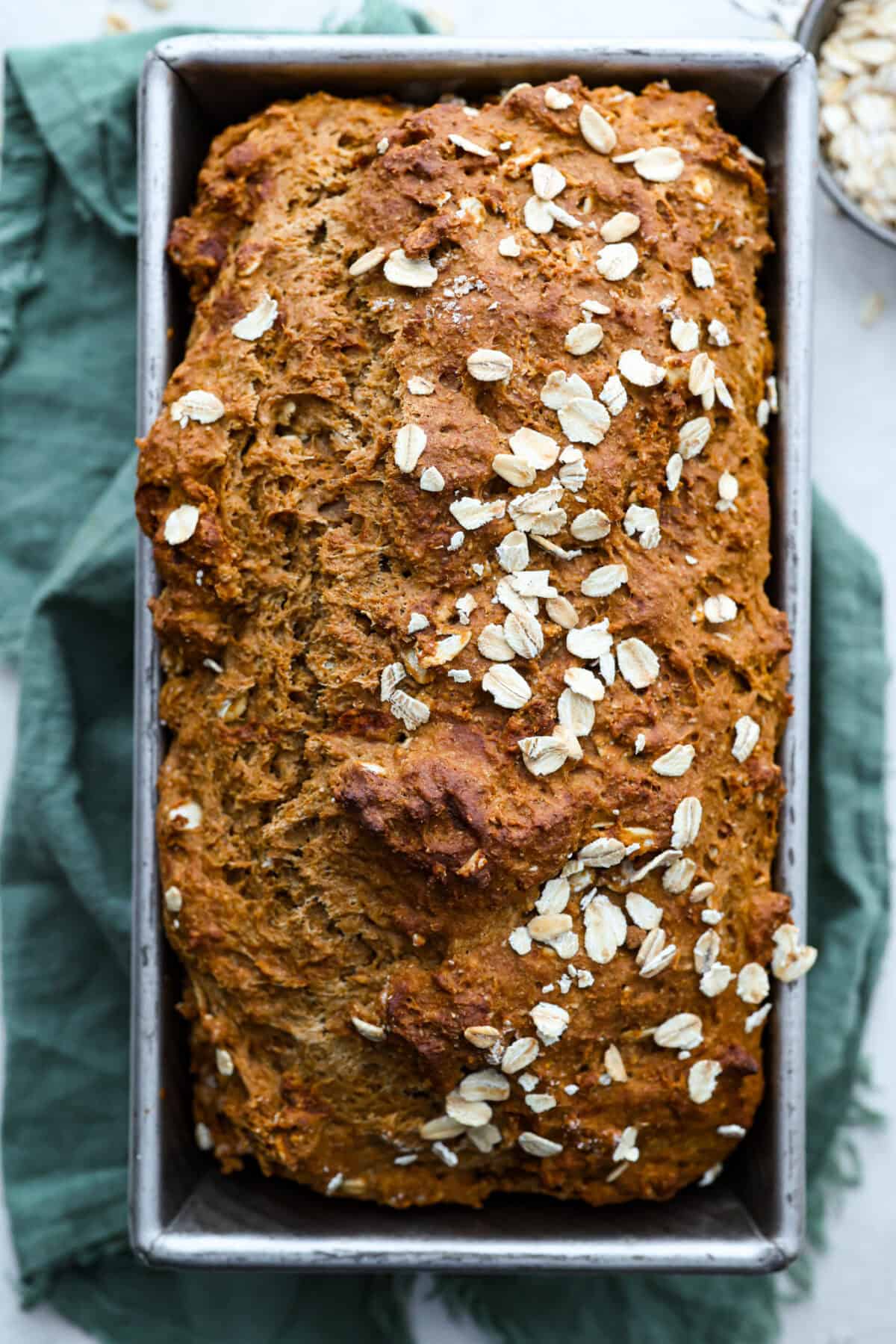 Overhead shot of freshly baked Irish brown bread cooling in a loaf pan. 