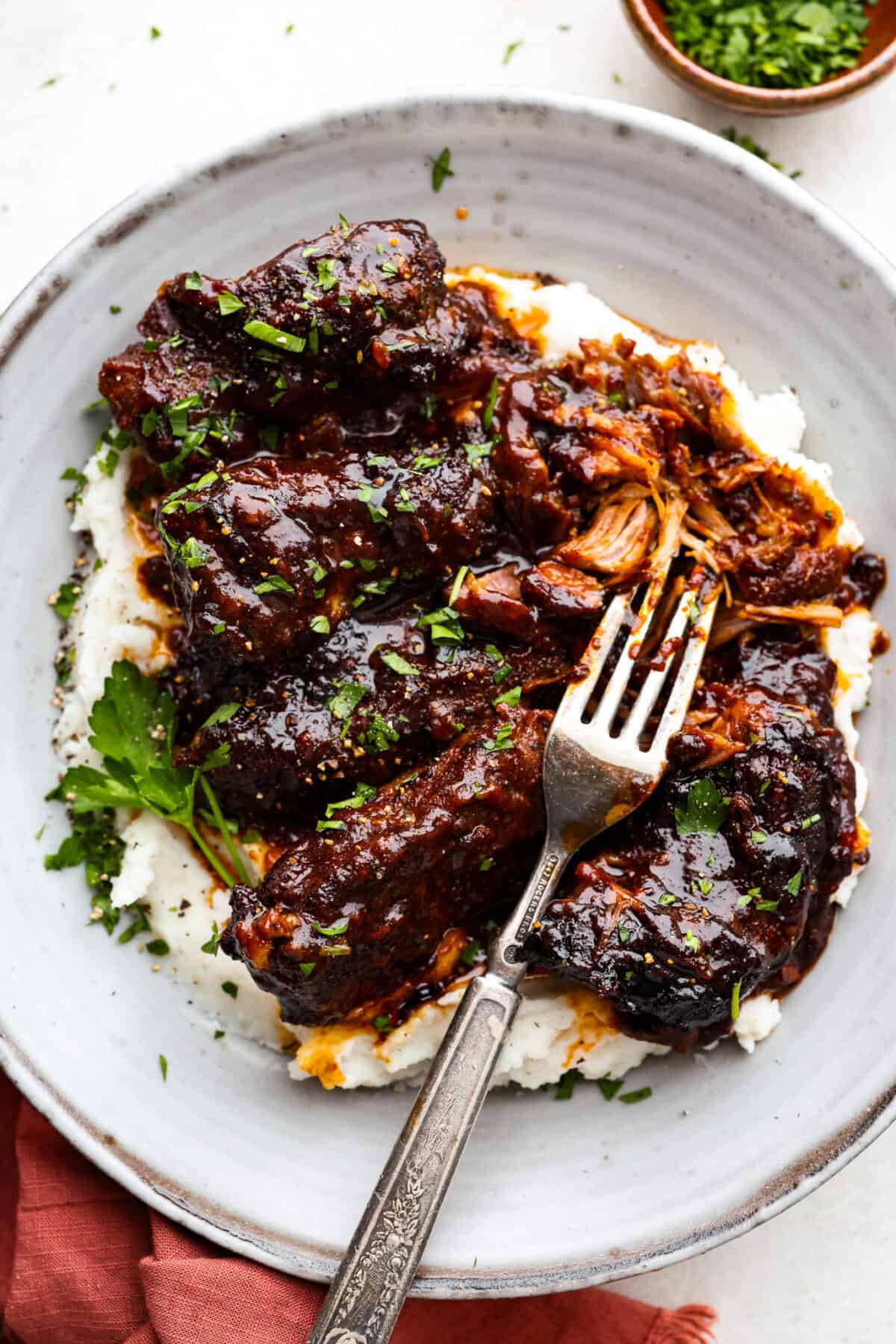 Overhead shot of plated slow cooker boneless pork ribs over mashed potatoes. 