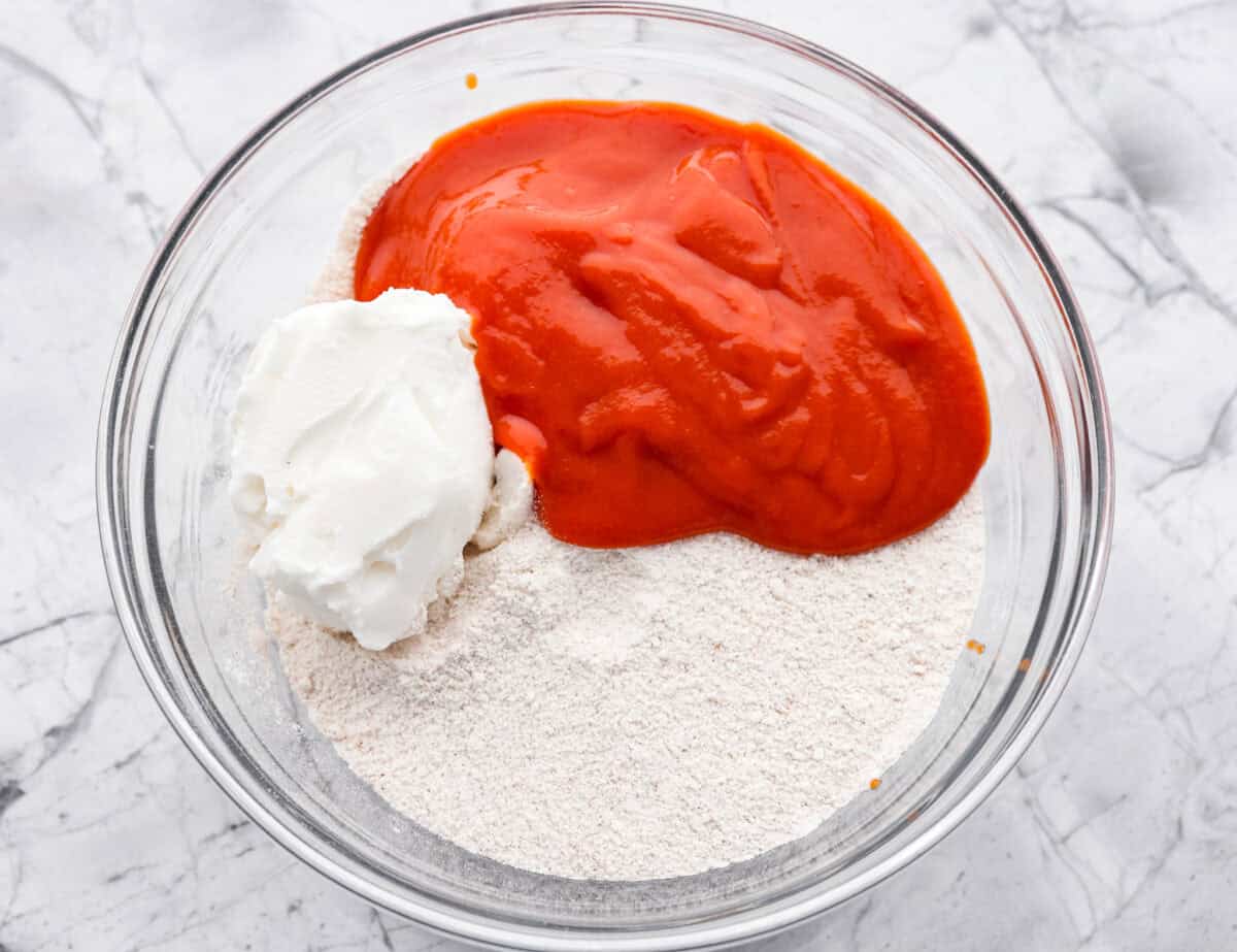 Overhead shot of dry ingredients with tomato soup and shortening on top. 