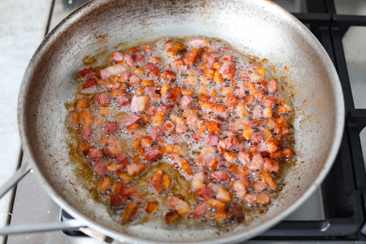 Pork cooking to render the fat in the skillet. 