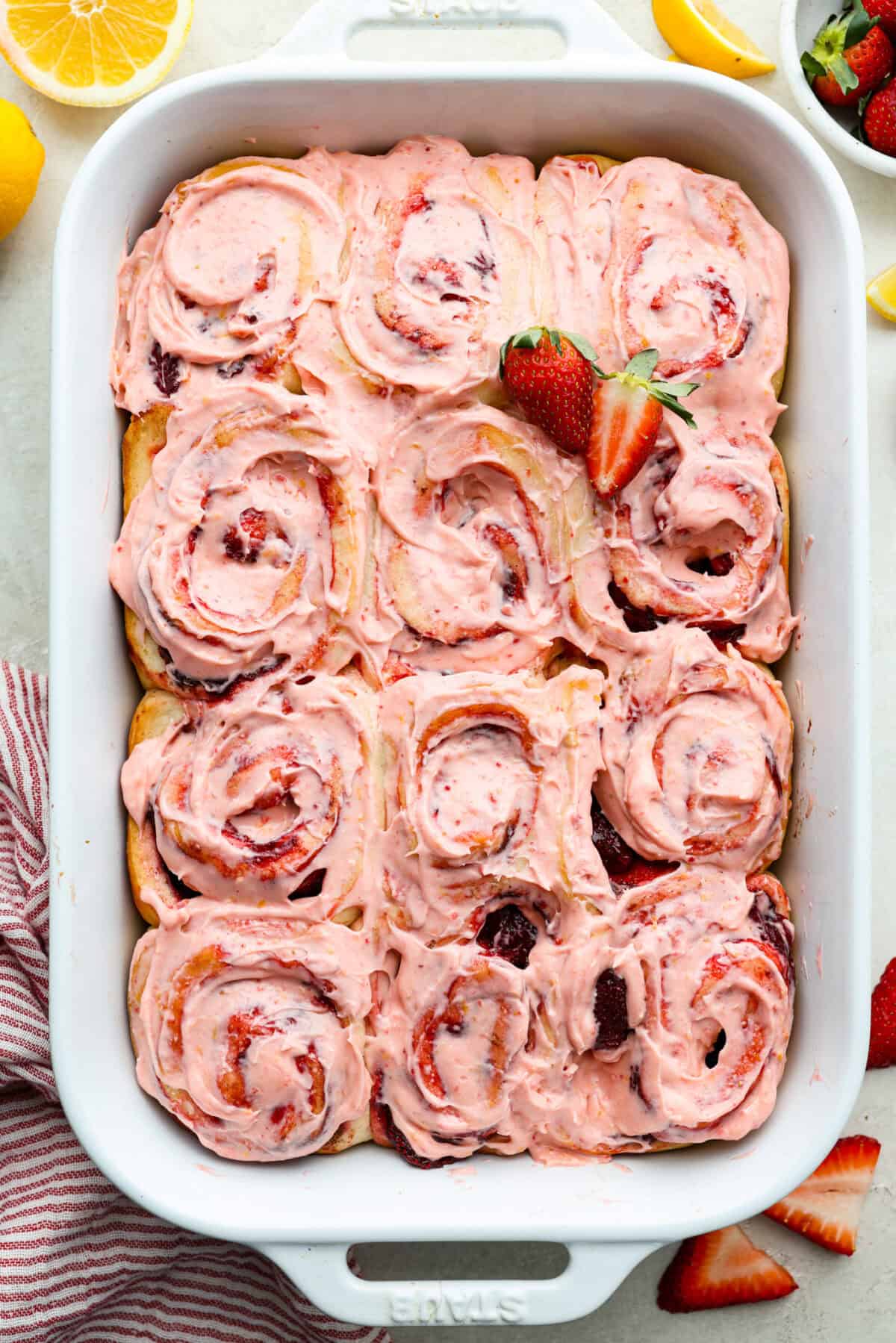 Overhead shot of strawberry cinnamon rolls in a baking dish. 