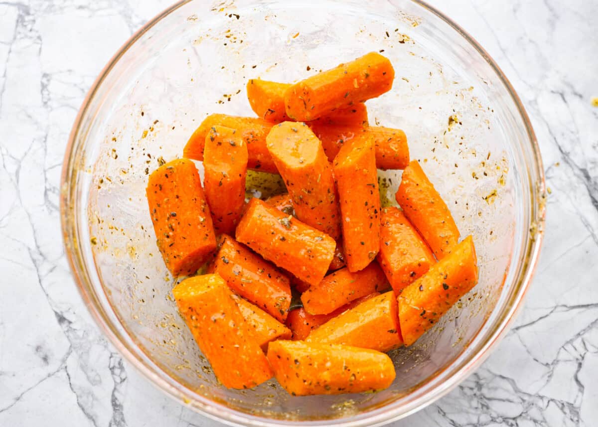Carrots seasoned in a glass bowl. 