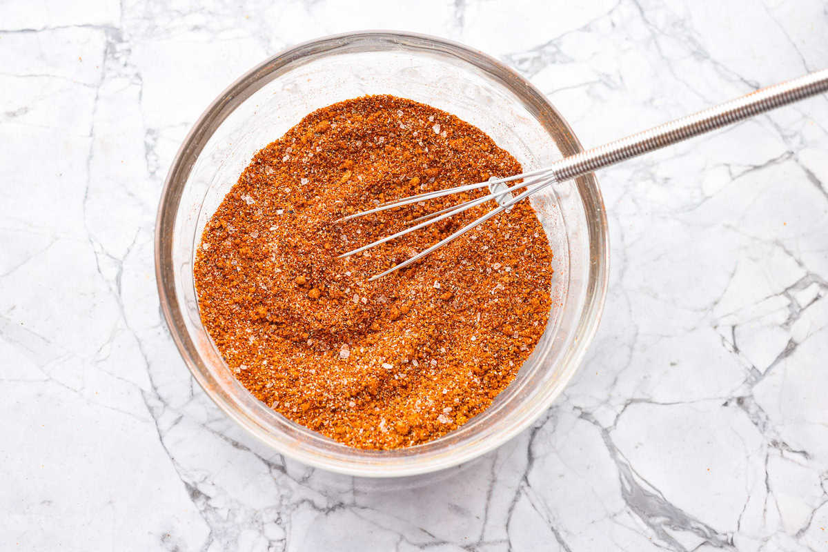 My homemade BBQ seasoning brings bold, smoky flavor to just about anything! It’s the perfect blend of sweet, savory, and just a little kick, ready to shake onto chicken, veggies, ribs, and more. A bowl with all of the ingredients whisked together.