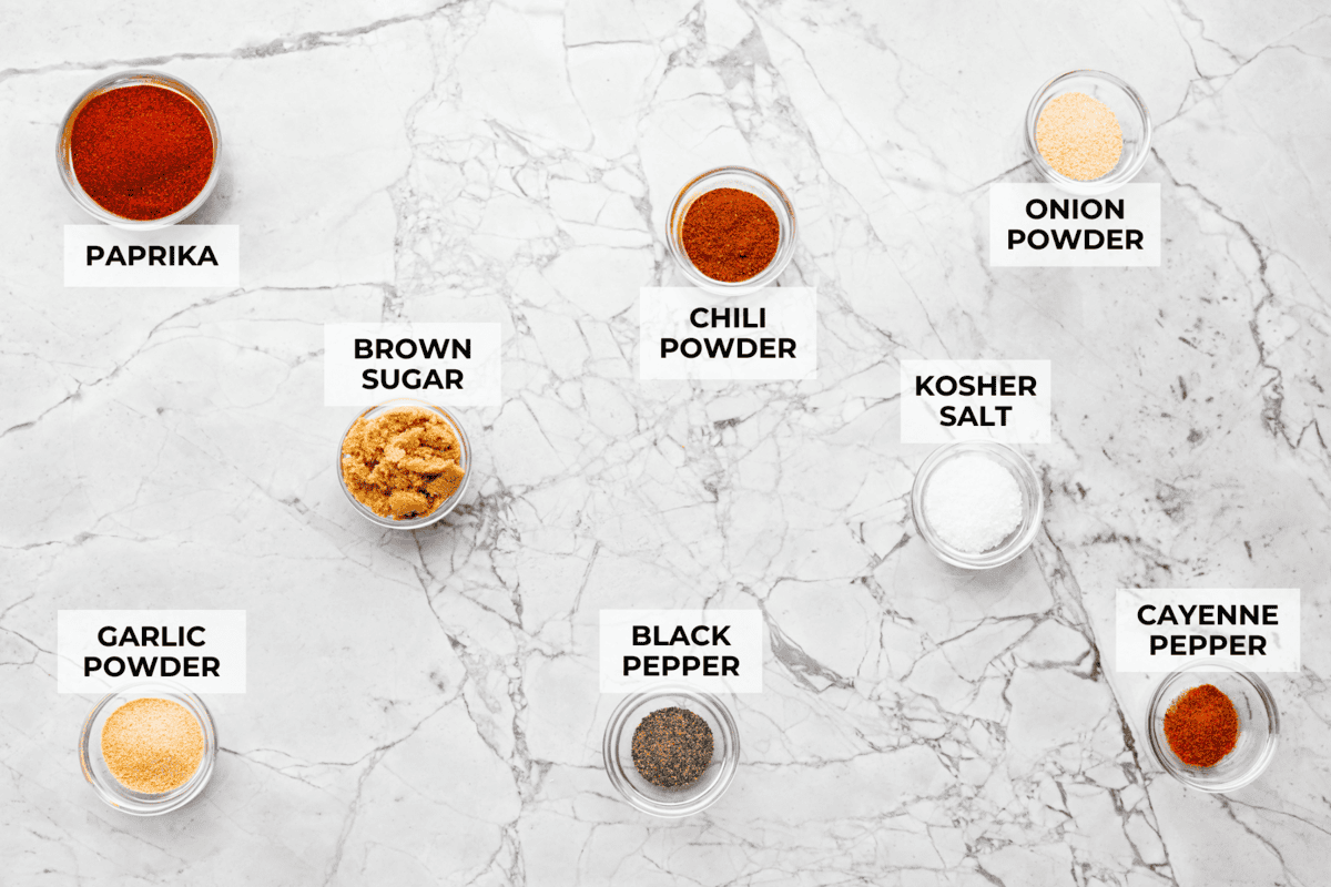 My homemade BBQ seasoning brings bold, smoky flavor to just about anything! It’s the perfect blend of sweet, savory, and just a little kick, ready to shake onto chicken, veggies, ribs, and more. Overhead shot of labeled ingredients.
