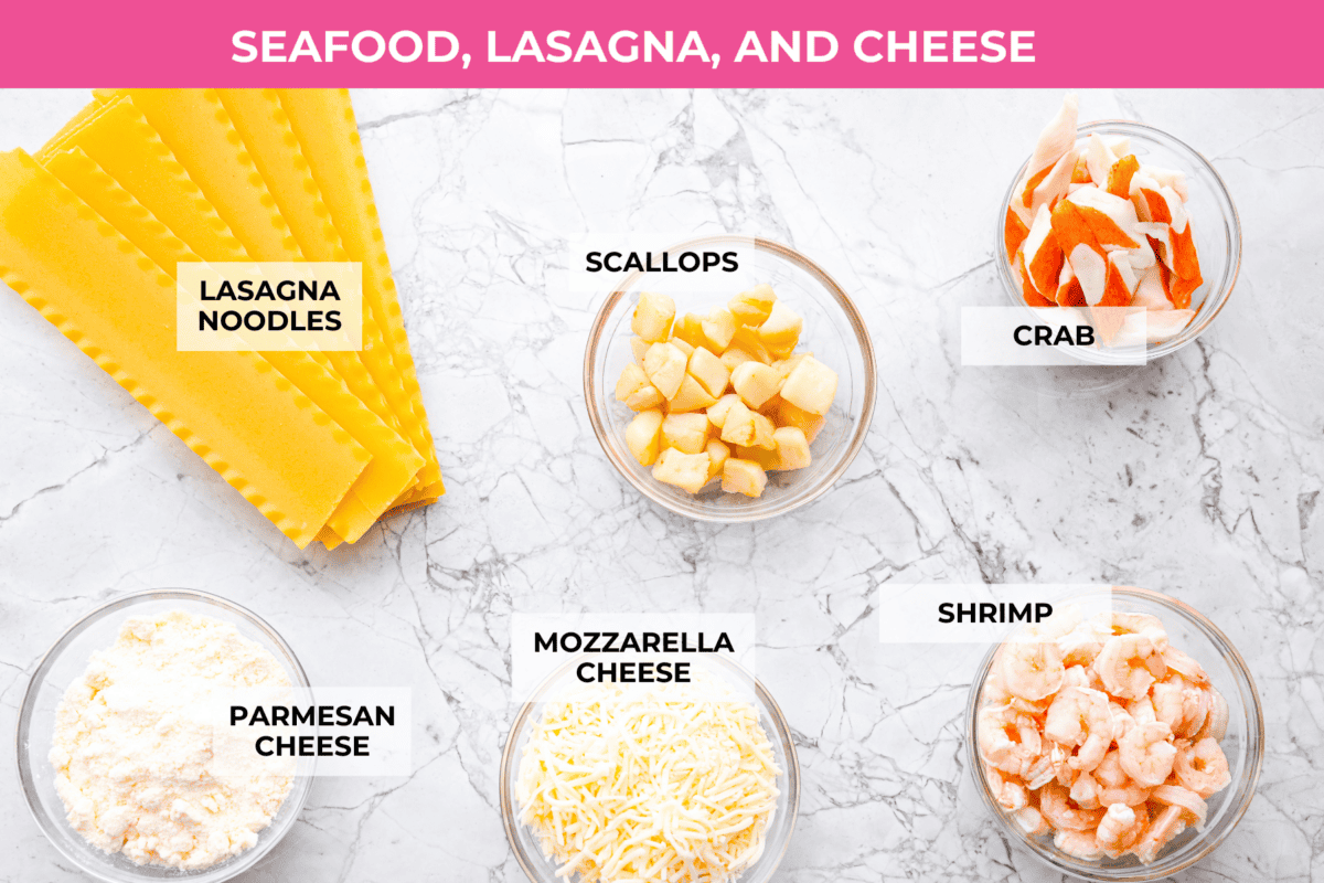 If you’re a seafood lover, you'll be obsessed with this Seafood Lasagna. I’m talking crab, scallops, and shrimp in creamy, cheesy layers, baked to bubbly perfection. It’s my go-to dinner when I’m cooking for seafood fans! Overhead shot of labeled seafood lasagna ingredients.