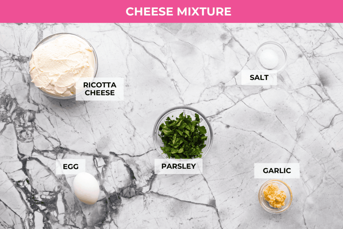If you’re a seafood lover, you'll be obsessed with this Seafood Lasagna. I’m talking crab, scallops, and shrimp in creamy, cheesy layers, baked to bubbly perfection. It’s my go-to dinner when I’m cooking for seafood fans! Overhead shot of labeled cheese mixture ingredients.
