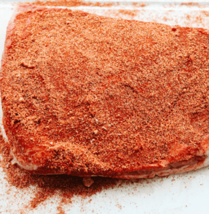 Brisket covered in seasoning. 