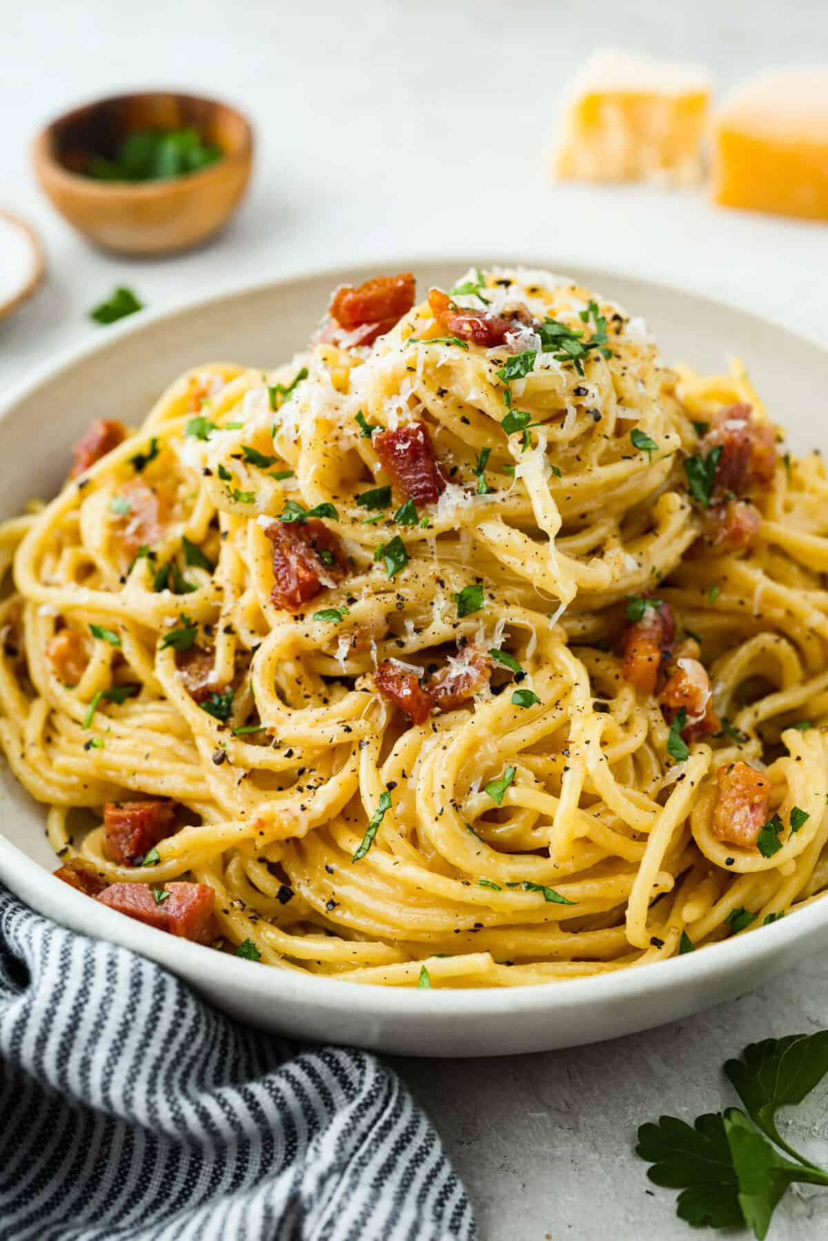 Angle shot of plated pasta carbonara.