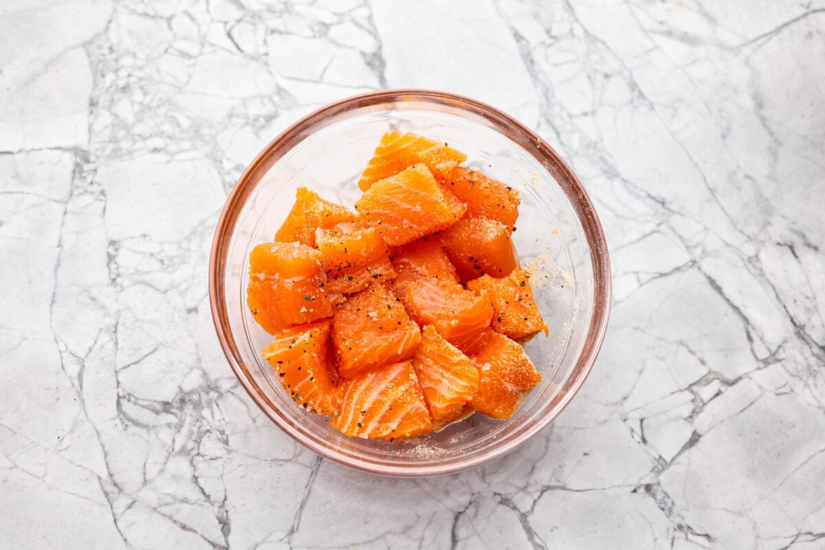Seasoned salmon pieces in a bowl. 