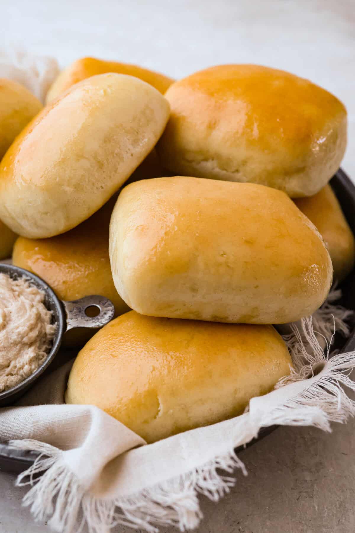 I am obsessed with Texas Roadhouse rollsโlike, zero self-control as soon as they hit the table. So, of course, I had to recreate them at home! These copycat Texas Roadhouse rolls are soft, fluffy, slightly sweet, and melt-in-your-mouth good. A basket full of copycat Texas Roadhouse rolls with cinnamon butter next to them.