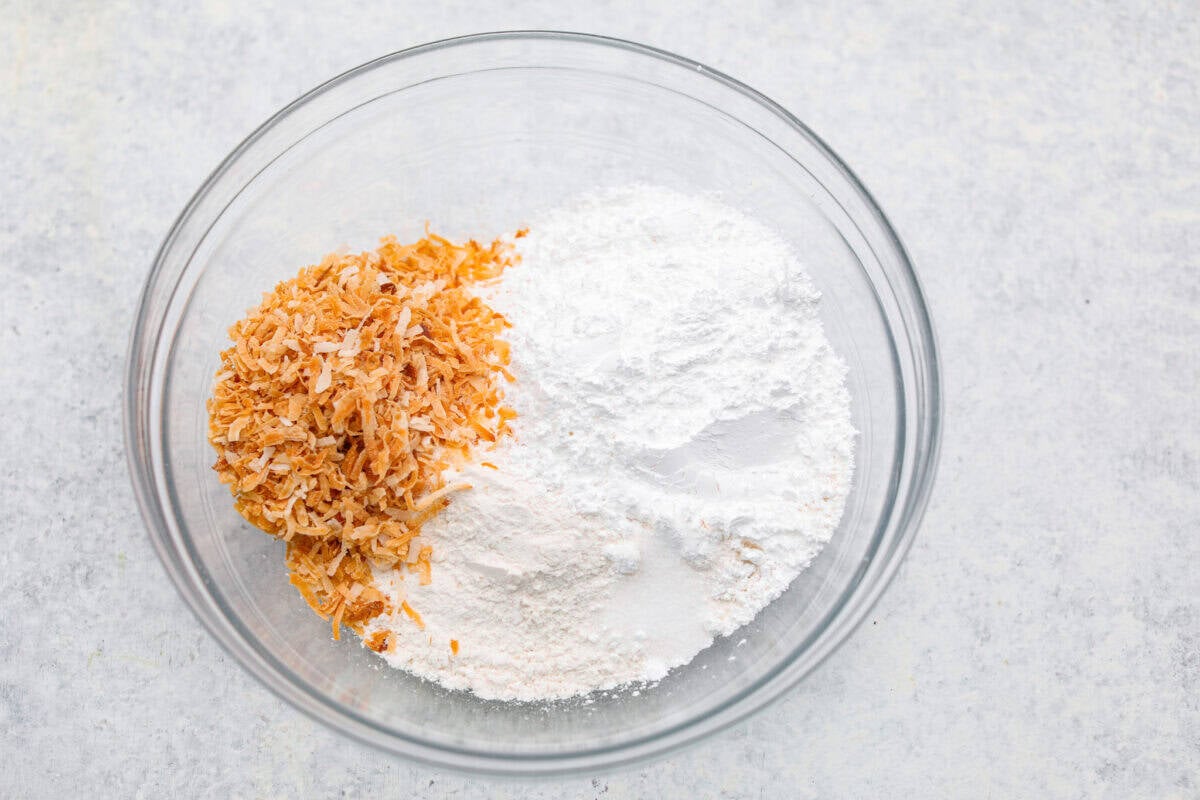 My Dad LOVES coconut cream pie! When I don't have it in me to make a pie, I make this easy Coconut Lush dessert! It’s rich, dreamy, and always the first dessert to disappear at family gatherings. Crust ingredients added to a bowl.