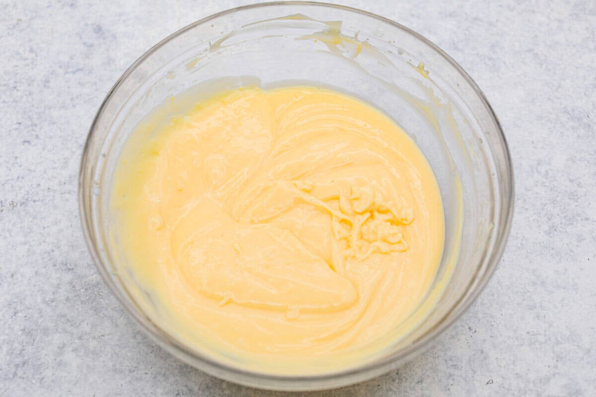 My Dad LOVES coconut cream pie! When I don't have it in me to make a pie, I make this easy Coconut Lush dessert! It’s rich, dreamy, and always the first dessert to disappear at family gatherings. Bowl of coconut pudding.