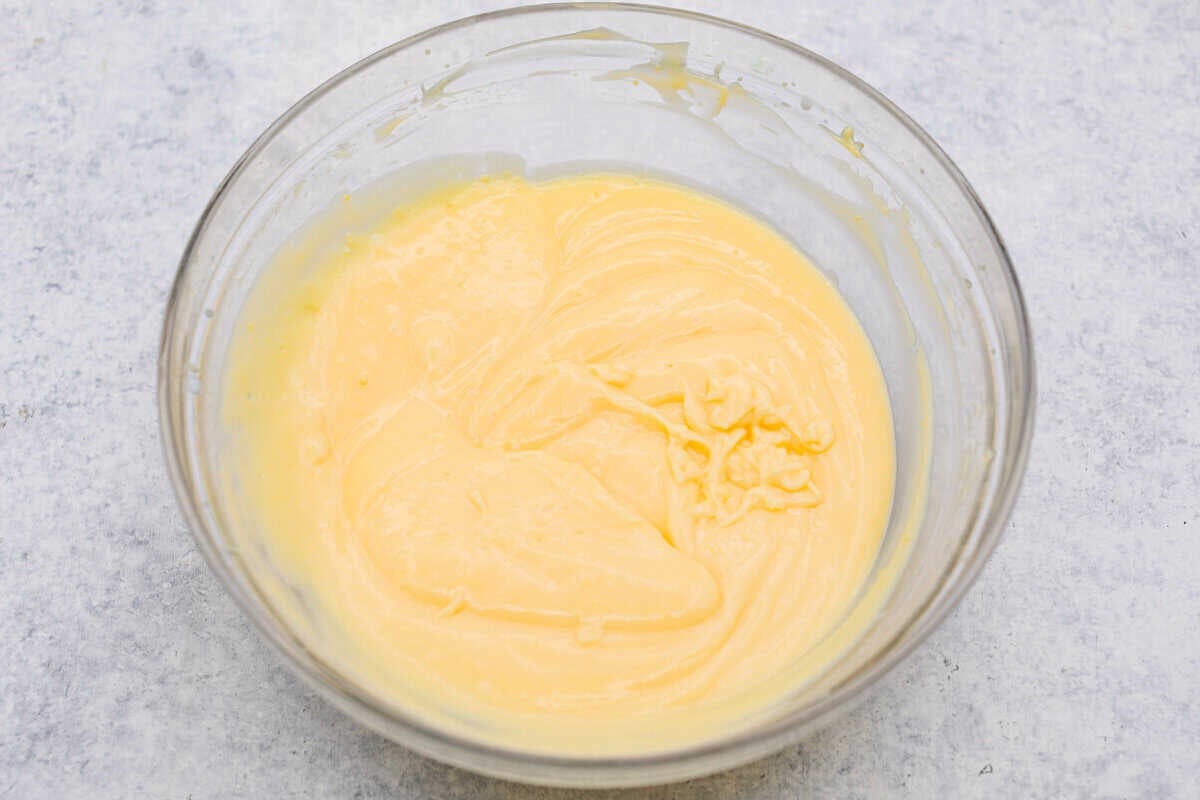 My Dad LOVES coconut cream pie! When I don't have it in me to make a pie, I make this easy Coconut Lush dessert! It’s rich, dreamy, and always the first dessert to disappear at family gatherings. Bowl of coconut pudding.