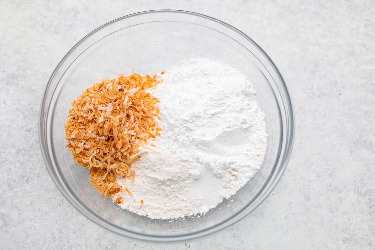 My Dad LOVES coconut cream pie! When I don't have it in me to make a pie, I make this easy Coconut Lush dessert! It’s rich, dreamy, and always the first dessert to disappear at family gatherings. Crust ingredients added to a bowl.