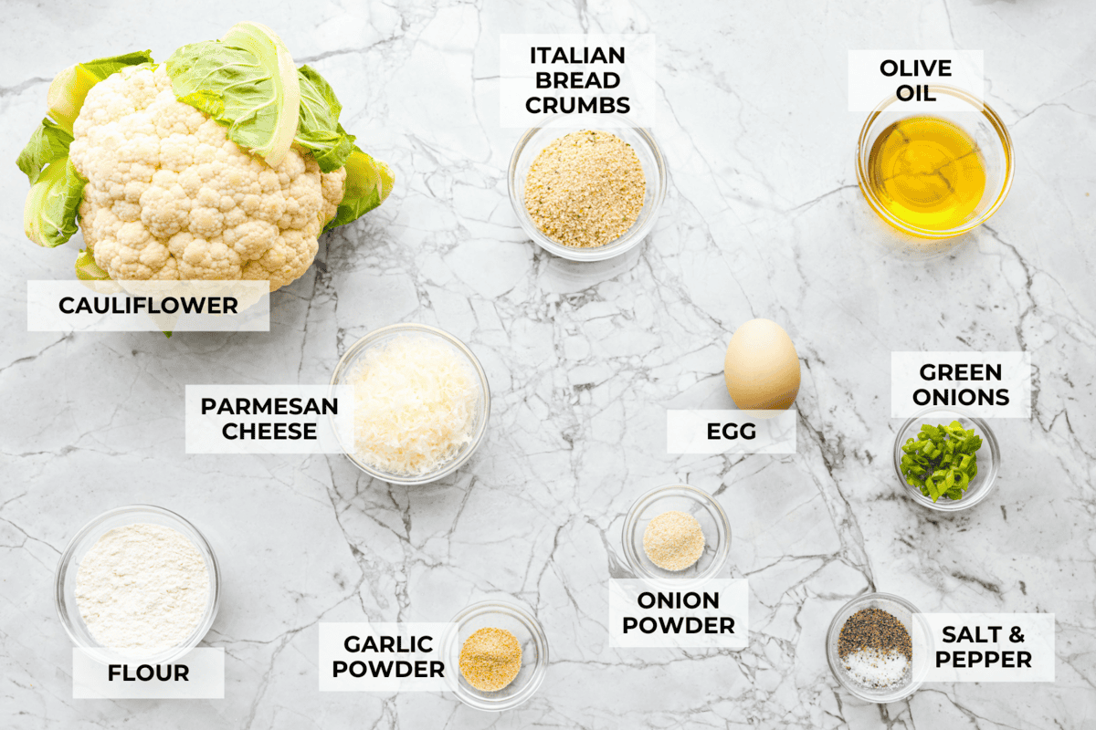 These crispy cauliflower fritters are how I trick my kids into eating veggies. They even ask for seconds. The parmesan and savory seasonings make these golden, cheesy, and packed with flavor! Overhead shot of labeled ingredients.
