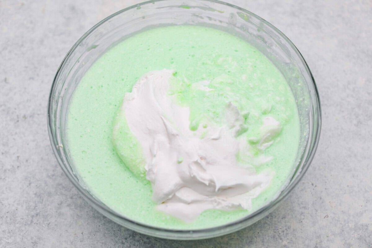 I gave the vintage lime Jello salad a modern makeover. With cream cheese for tang, pineapple and lime for zip, and a splash of 7-Up for that light, fizzy fluff, this retro-inspired treat is now a sweet, citrusy dream I know you guys will love! Whipped topping added to the 7Up and cream cheese mixture.