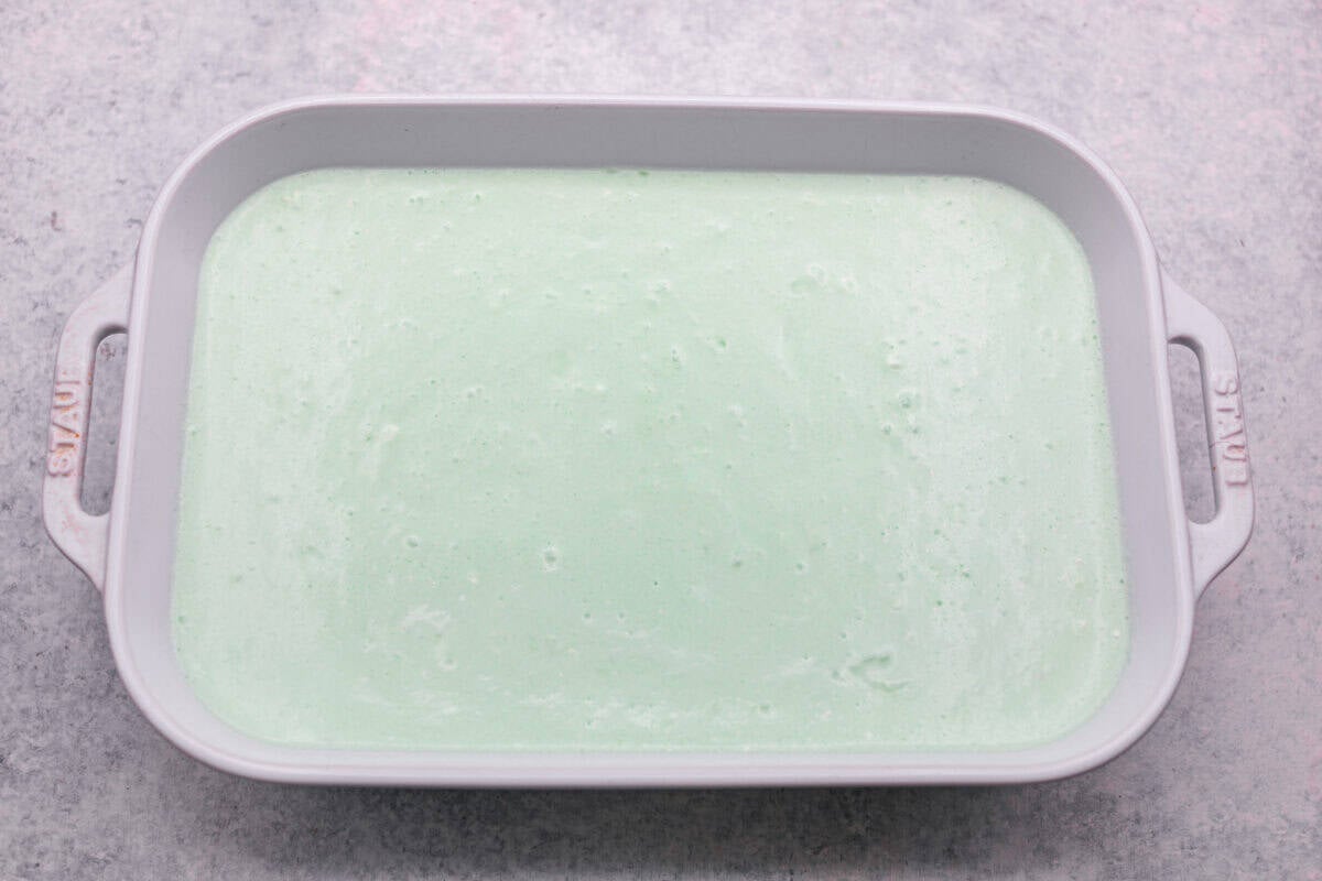I gave the vintage lime Jello salad a modern makeover. With cream cheese for tang, pineapple and lime for zip, and a splash of 7-Up for that light, fizzy fluff, this retro-inspired treat is now a sweet, citrusy dream I know you guys will love! All of the lime jello salad ingredients mixed together and added to the prepared baking dish.