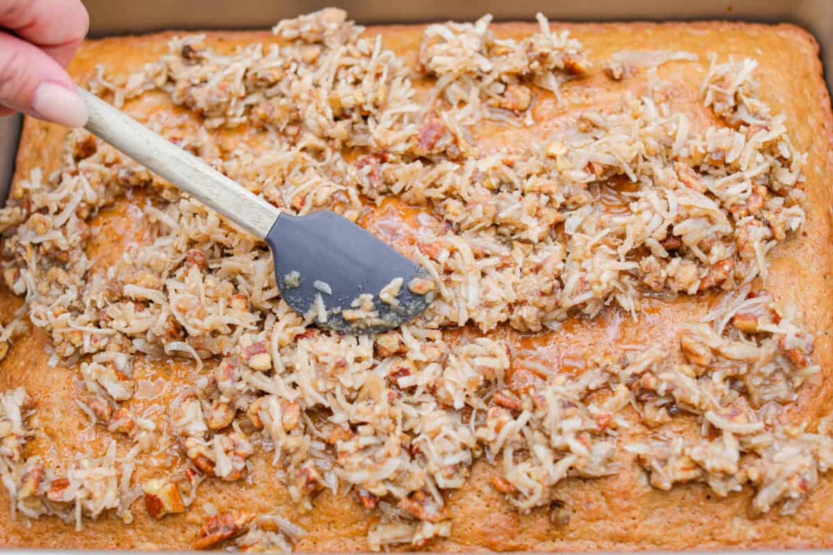 Cooked cake topped with frosting ingredients. 