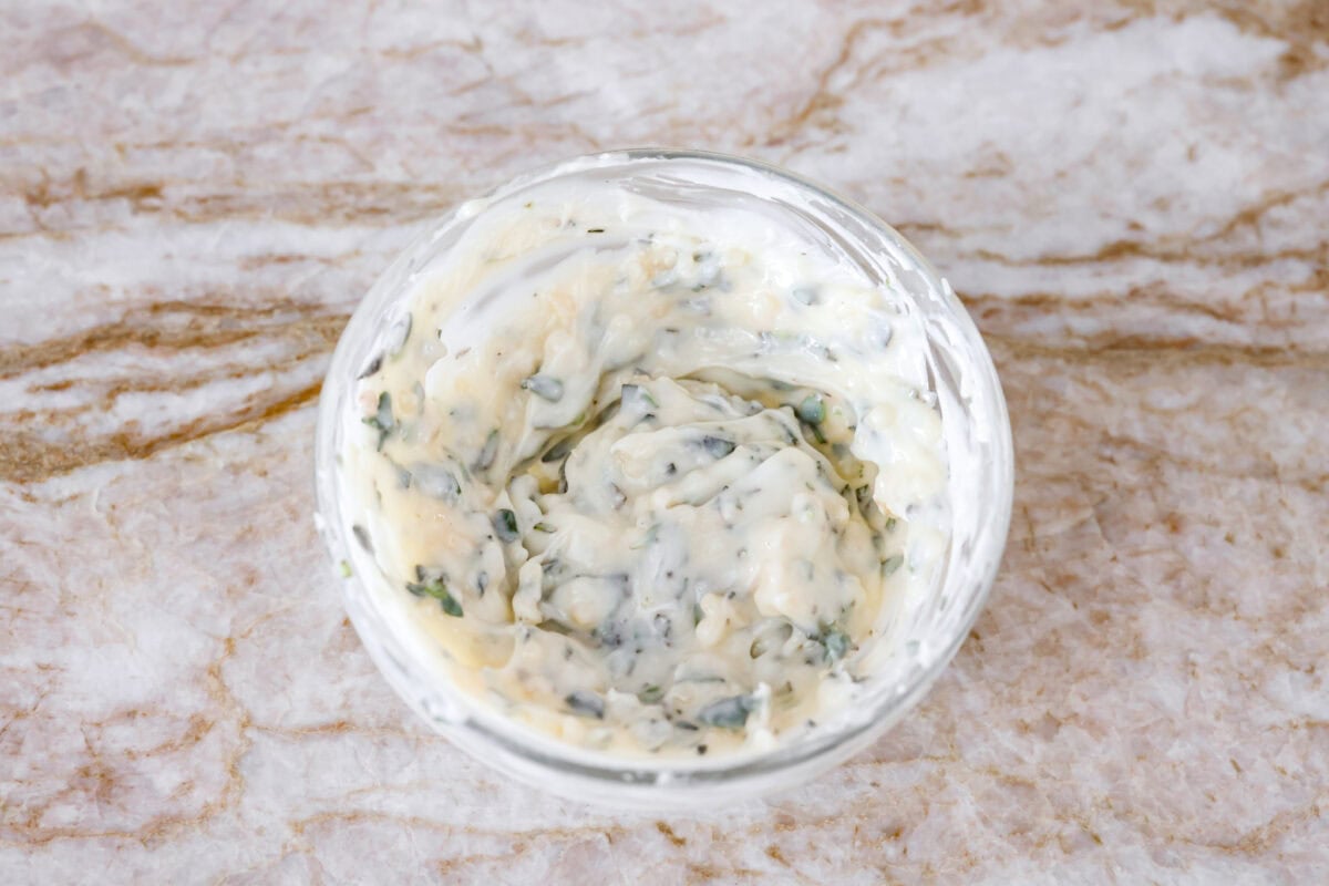 Garlic butter herb ingredients mixed together in a bowl. 
