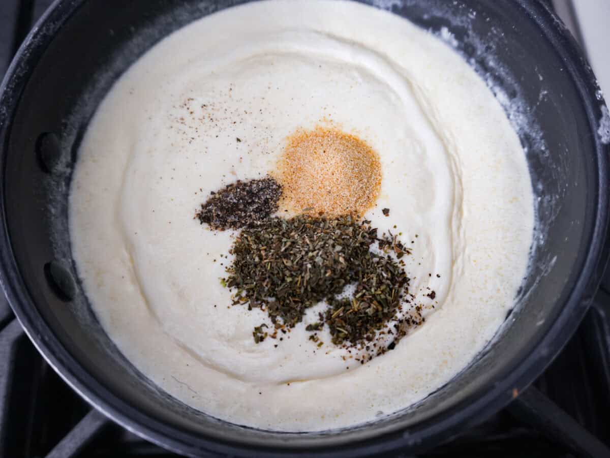 Alfredo sauce is one of my most popular recipes EVER! The secret is a little cream cheese, and ohhh my gosh, the tangy creaminess takes it to the next level. You and your kids will inhale it, I promise! Seasonings added to the melted cream, cream cheese and butter mixture.