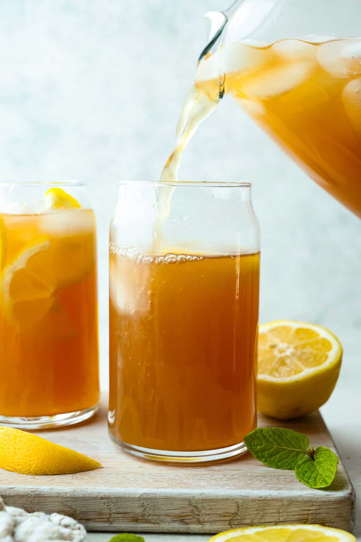 If you love iced tea, you’re going to be obsessed with this Arnold Palmer. The combo of crisp black tea and tangy lemonade is pure summer magic. It’s simple, refreshing, and always just what you need. Someone pouring Arnold Palmer mix into a tall glass with ice and lemon slices.