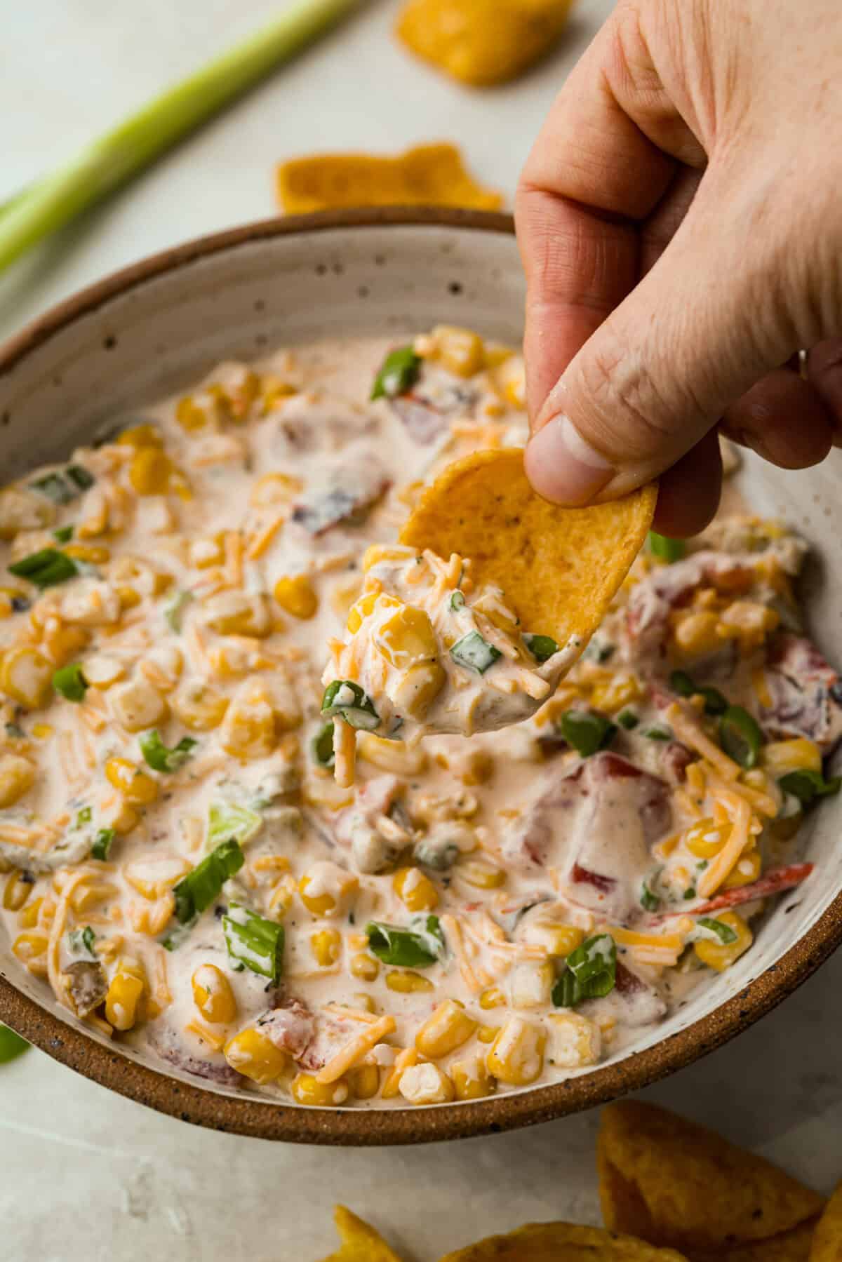 1Y3A2650 Someone scooping crack corn dip with a corn chip.