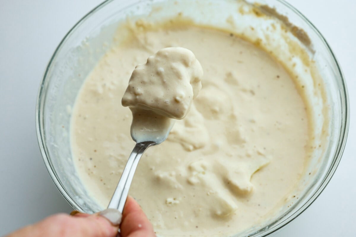 Cauliflower floret dipped into the batter. 
