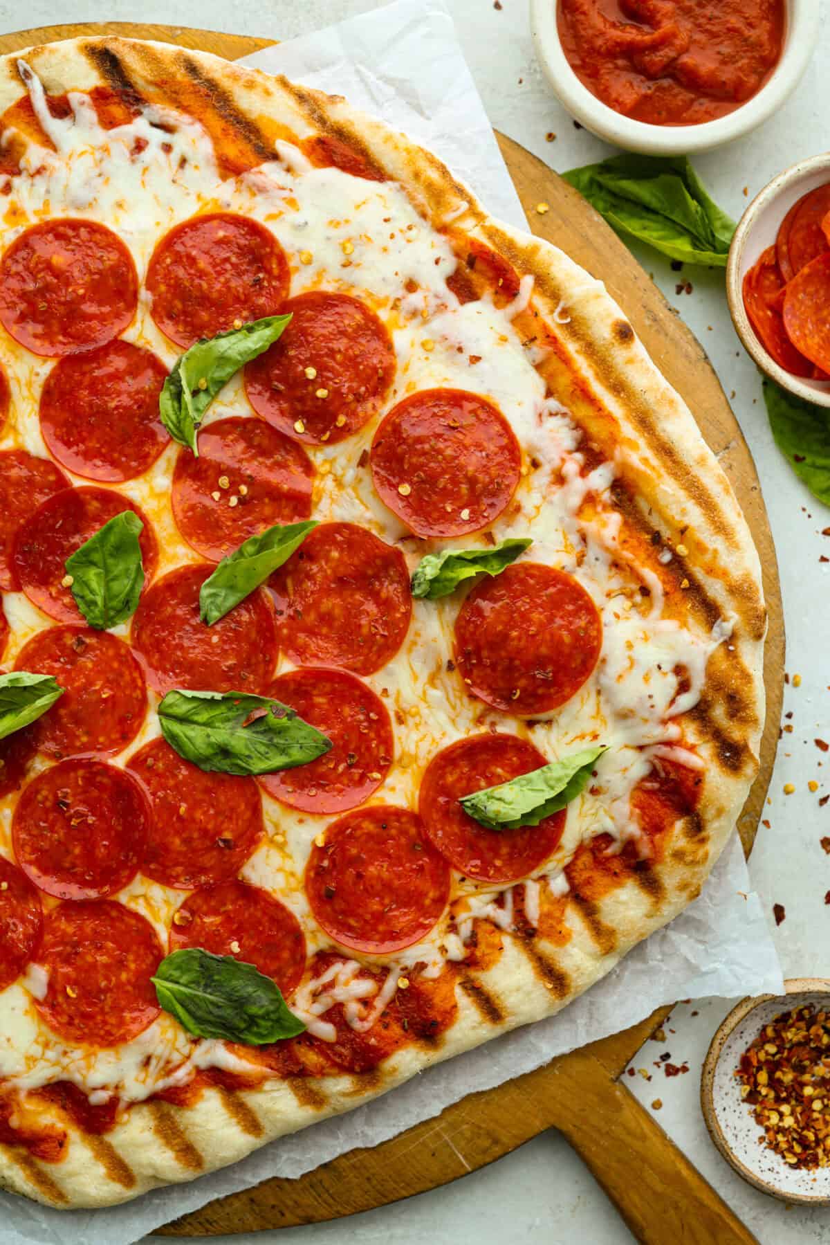 I’m all about pizza and grilling, so when I can combine the two, it’s a win. The grill gives pizza that smoky, crispy flavor you can’t get from the oven. Trust me, this grilled pizza will have you hooked! Overhead shot of grilled pizza.