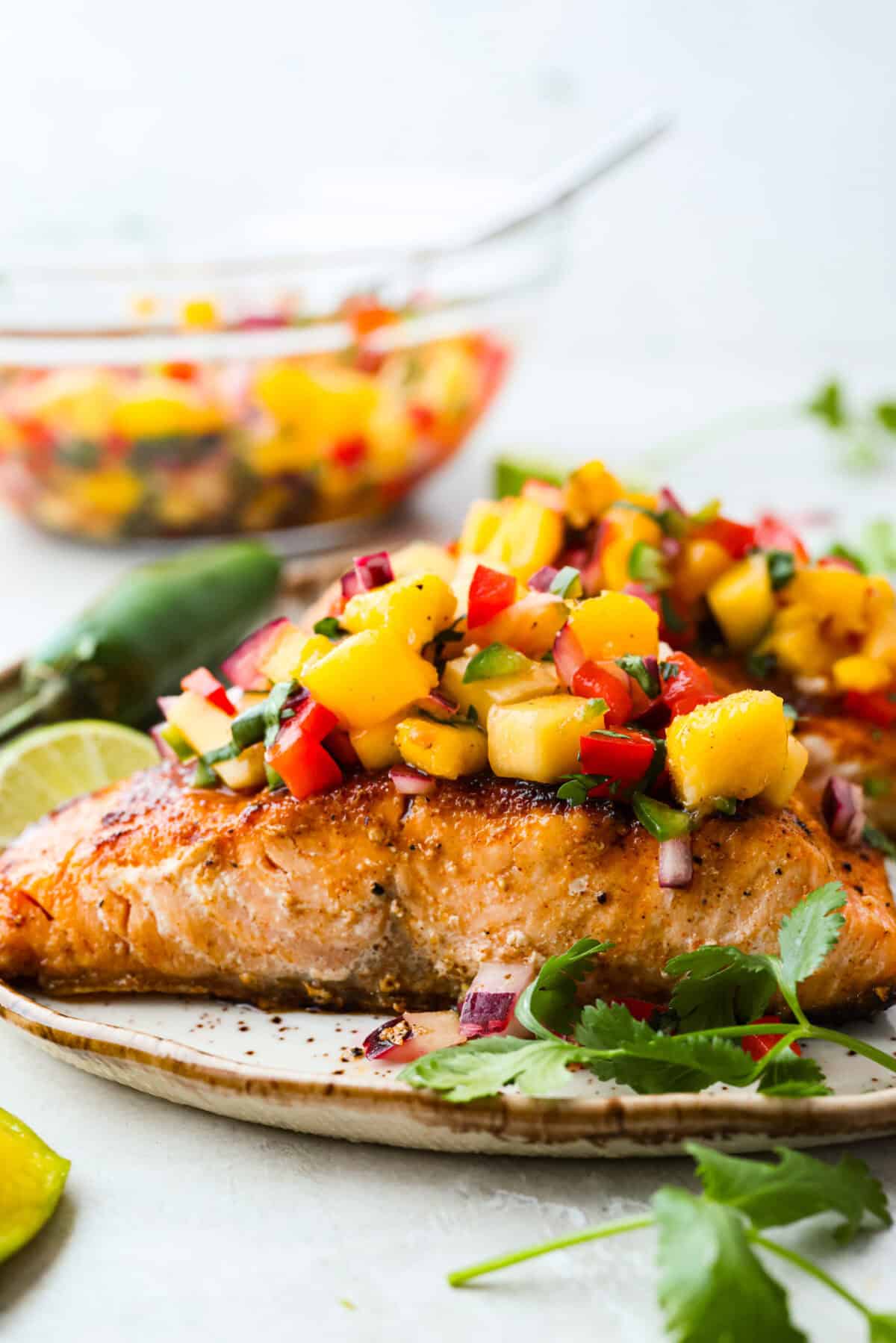 I’m obsessed with salmon, and this Mango Salsa Salmon might just be my new favorite! It’s super flavorful, fast to cook, and somehow my kids don’t fight me on it. That bright, juicy salsa on top? Freaking amazing. I could eat it every night! Side shot of plated mango salsa salmon.