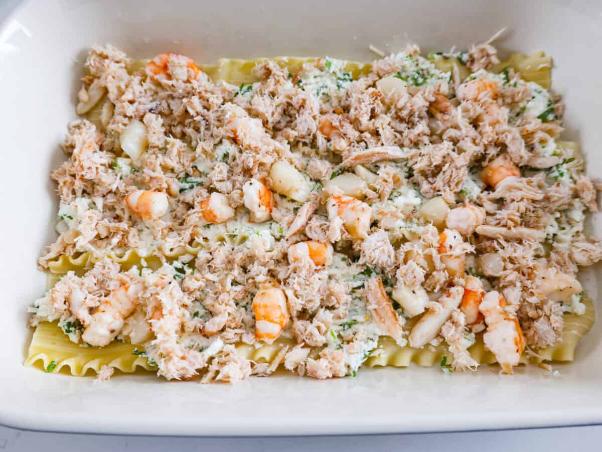 If you’re a seafood lover, you'll be obsessed with this Seafood Lasagna. I’m talking crab, scallops, and shrimp in creamy, cheesy layers, baked to bubbly perfection. It’s my go-to dinner when I’m cooking for seafood fans! Seafood mixture added on top of the ricotta mixture.