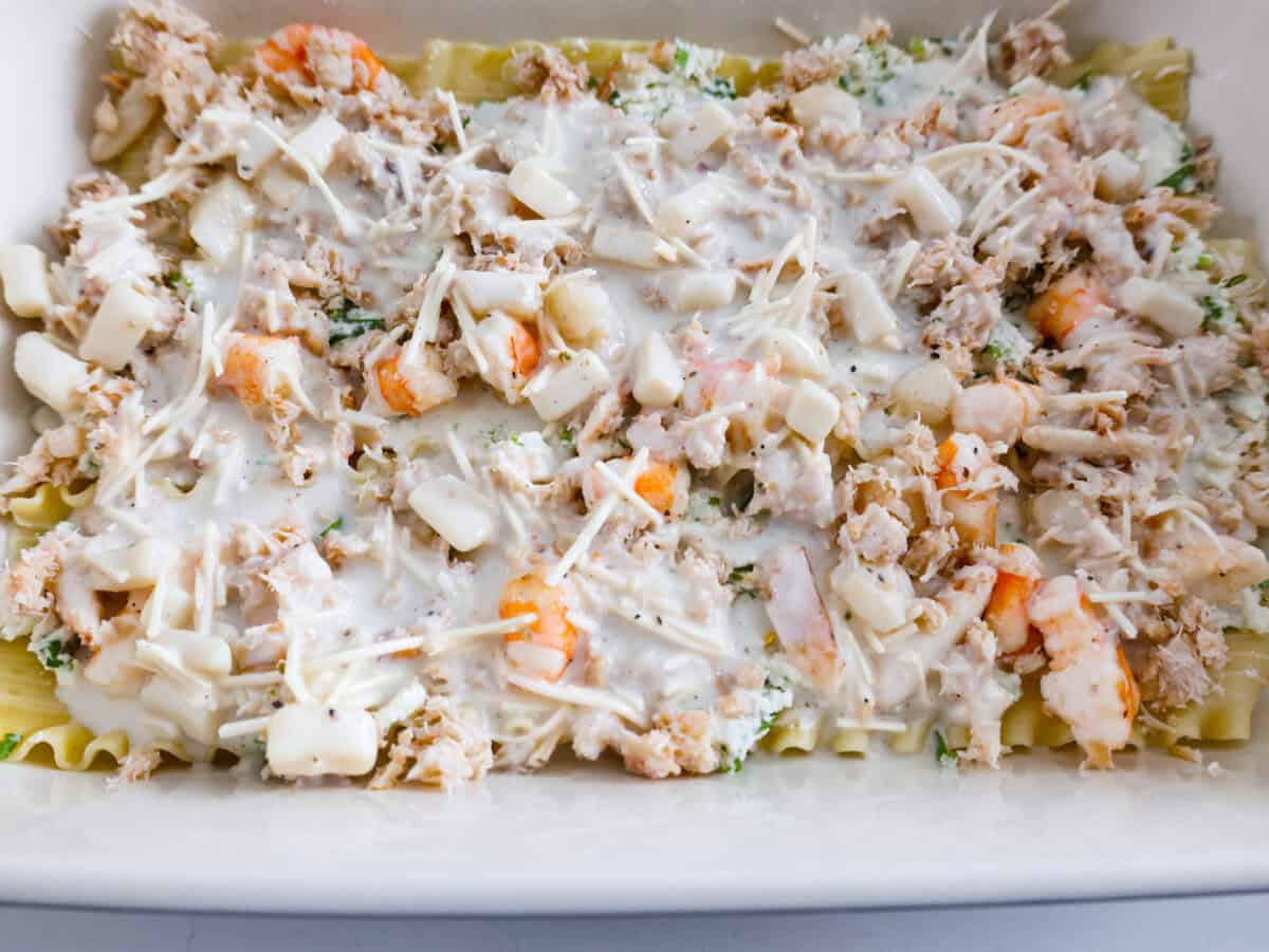 If you’re a seafood lover, you'll be obsessed with this Seafood Lasagna. I’m talking crab, scallops, and shrimp in creamy, cheesy layers, baked to bubbly perfection. It’s my go-to dinner when I’m cooking for seafood fans! Sauce poured on top of the seafood lasagna layers.